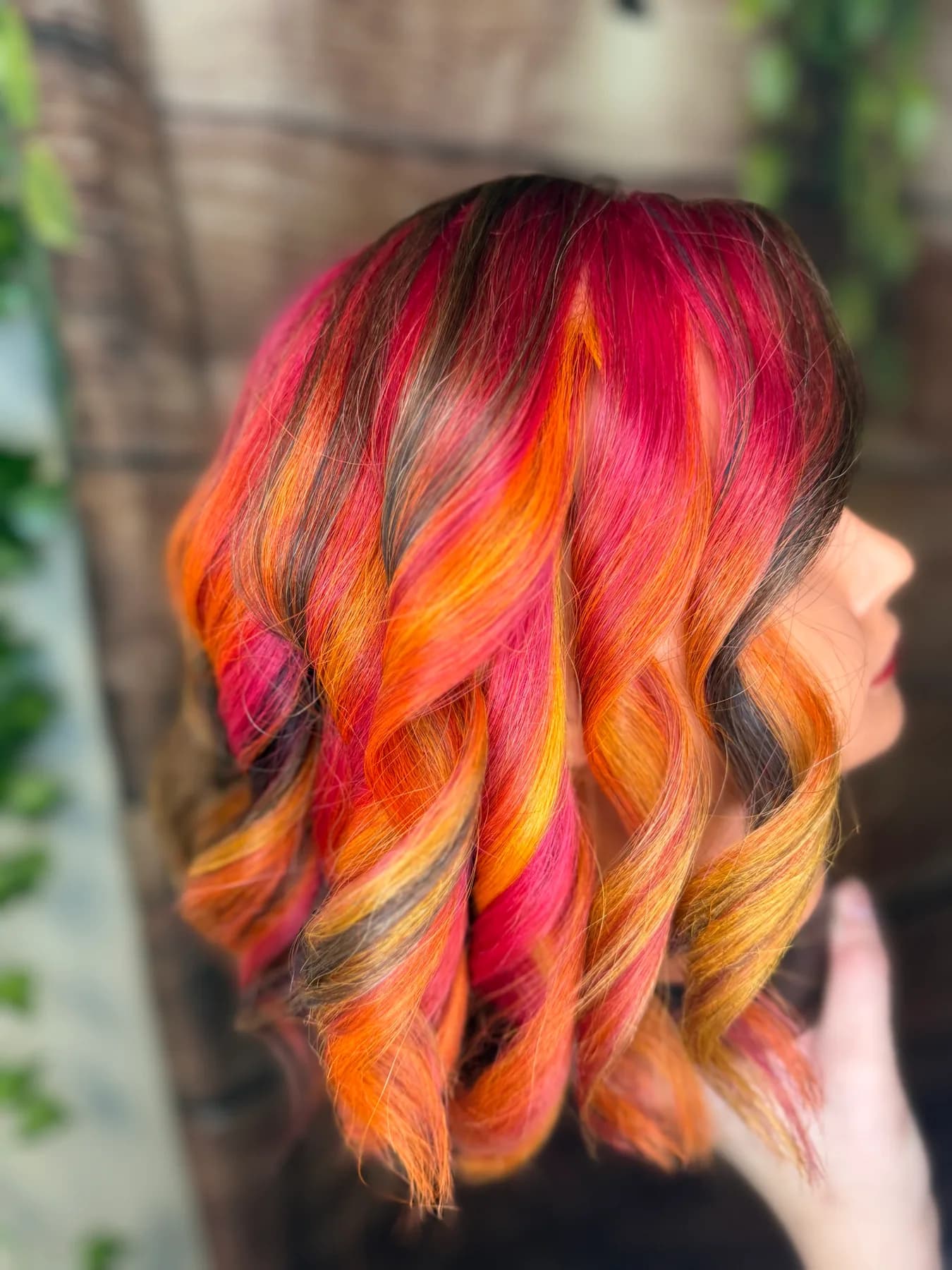 Vivid red, orange, and yellow fashion color by Hair Haven