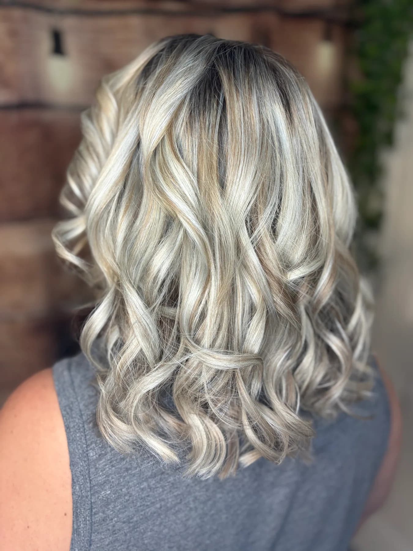 Icy blonde highlights in soft waves by Hair Haven